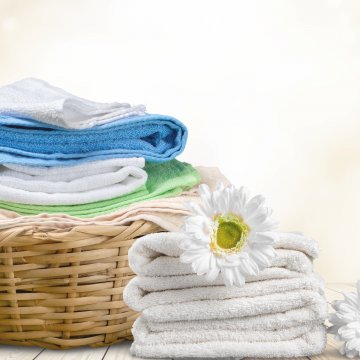 basket of clean folded laundry flowers on top of towels whirlpool WTW5000DW top-load washing machine 